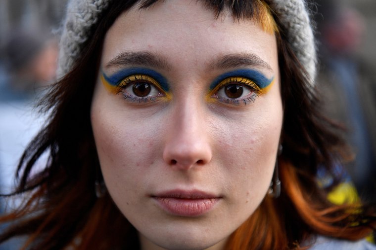 Image: A demonstrator wears eye shadow with the colors of the Ukrainian flag at an anti-war protest in Dublin, Ireland, on Feb. 24, 2022.