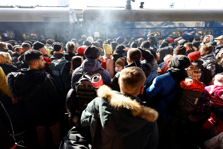 Image: People wait to board a evacuaition train from Kyiv to Lviv at Kyiv central train station