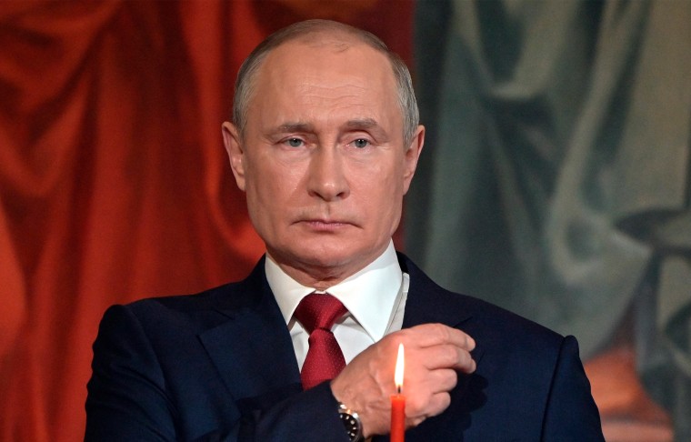 Image: Vladimir Putin crosses himself during the Easter service.