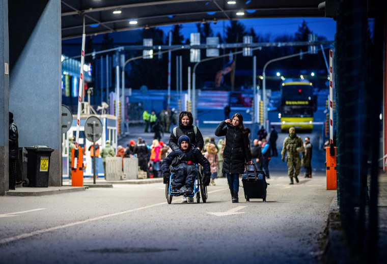 Image: Ukrainian refugees are seen at the Slovak-Ukrainian border crossing in Vysne Nemecke, eastern Slovakia, on Feb. 26, 2022.
