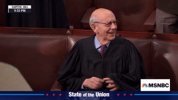 Image; Justice Stephen Breyer of the Supreme Court reacts to applause.