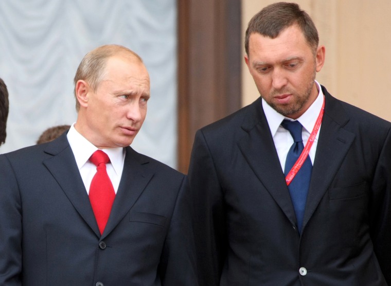 Then Russian Prime Minister Vladimir Putin speaks with Oleg Deripaska at an investment forum in Sochi in 2008.