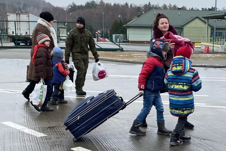 Women and children cross into Poland at the Hrebenne border on Wednesday.