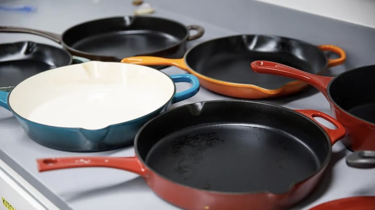 An array of enameled cast-iron skillets in CR's cookware lab.
