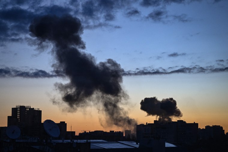 Smoke rises from a building after an explosion at dawn in Kyiv on Wednesday.