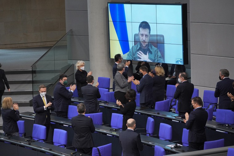 Ukrainian President Volodymyr Zelenskyy speaks via video link to the German Bundestag and receives applause from lawmakers on Thursday in Berlin.