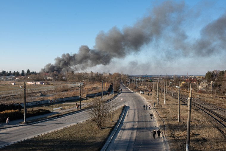 Smoke is seen above buildings close to the airport in Lviv, Ukraine on Friday morning.
