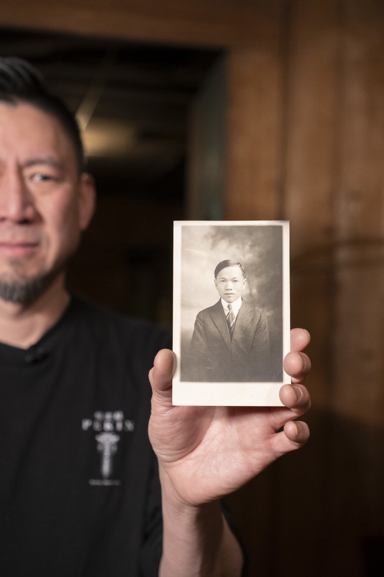 Jerry Tam, the owner of the Pekin Noodle Parlor in Butte, Montana, holds a photo of his great-grandfather who helped open the more than century-old restaurant.