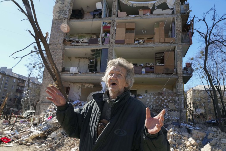 A man reacts standing near his house ruined after Russian shelling in Kyiv, Ukraine, on Monday.