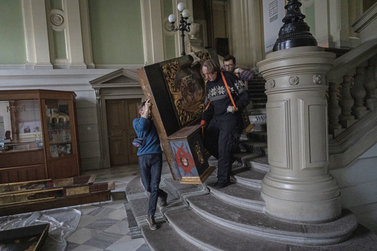 Image: Workers move a baroque sacred art piece in the Andrey Sheptytsky National Museum as part of safety preparations in Lviv, Ukraine, on March 4, 2022.