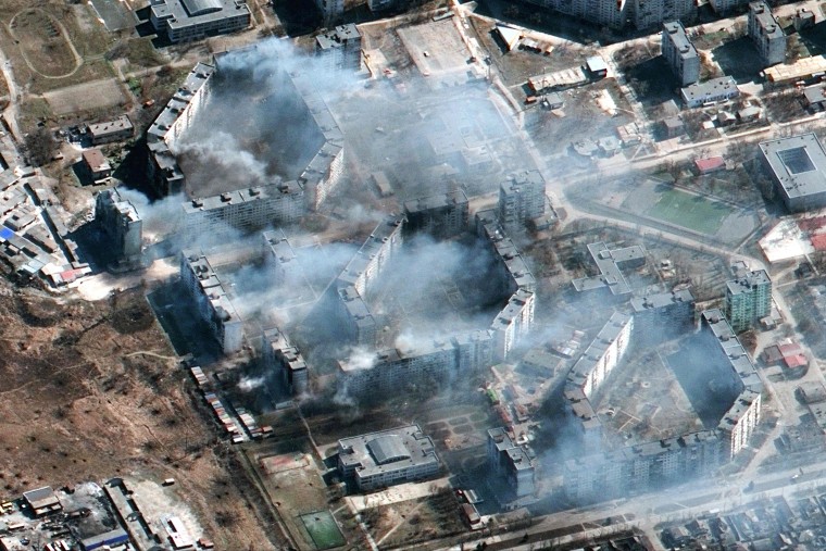 This Maxar satellite image taken on March 19, 2022 and released on March 21, 2022 shows burning apartment buildings in northeastern Mariupol, Ukraine.
