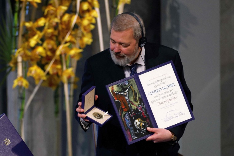 Nobel Peace Prize laureate Dmitry Muratov of Russia poses with the Nobel Peace Prize diploma and medal during the gala award ceremony in Oslo, Norway on Dec. 10, 2021.