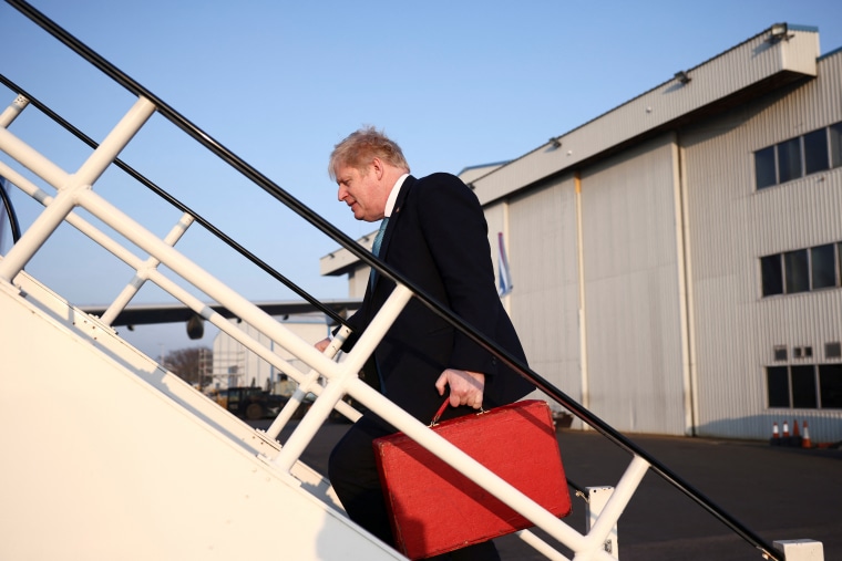 British Prime Minister Boris Johnson boards a plane to Brussels to take part in a NATO summit to discuss Russia's invasion of Ukraine, at London Stansted airport, on Thursday.
