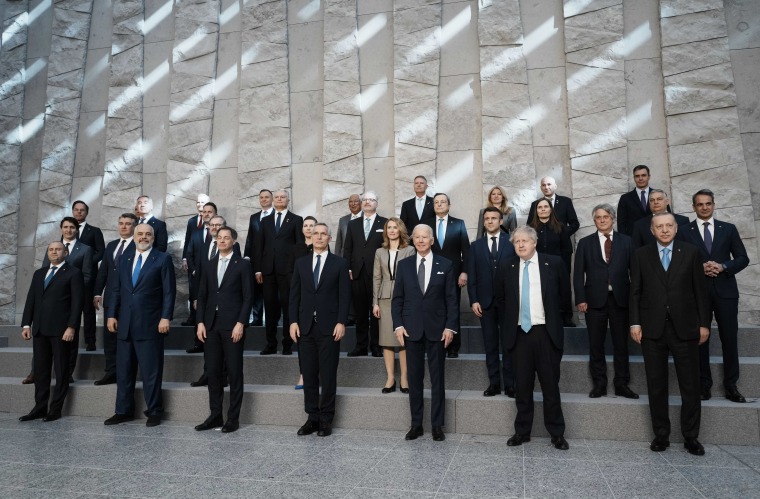 NATO heads of state pose for a group photo during an extraordinary summit at NATO headquarters in Brussels on Thursday.