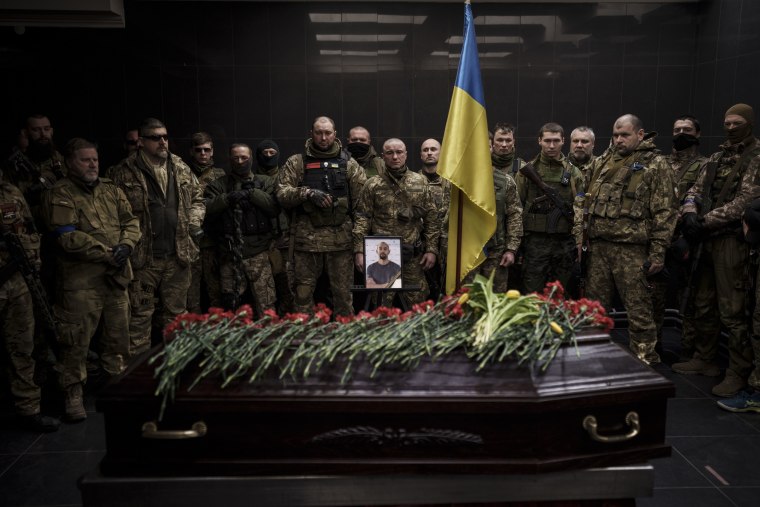 Ukrainian servicemen attend a funeral for marine Alexandr Khovtun in Kyiv on Sunday, March 20, 2022. Khovtun died in combat in the town of Huta-Mezhyhirska, north of Kyiv.