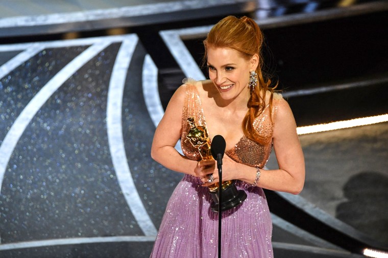 Jessica Chastain accepts the award for best performance by an actress in a leading role for "The Eyes of Tammy Faye" at the Oscars on Sunday in Los Angeles.