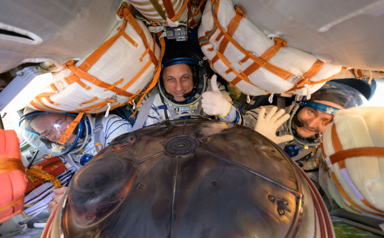 Russian cosmonauts Pyotr Dubrov and Anton Shkaplerov and NASA astronaut Mark Vande Hei are seen inside the Soyuz MS-19 space capsule shortly after the landing in a remote area outside Dzhezkazgan, Kazakhstan, on March 30, 2022.