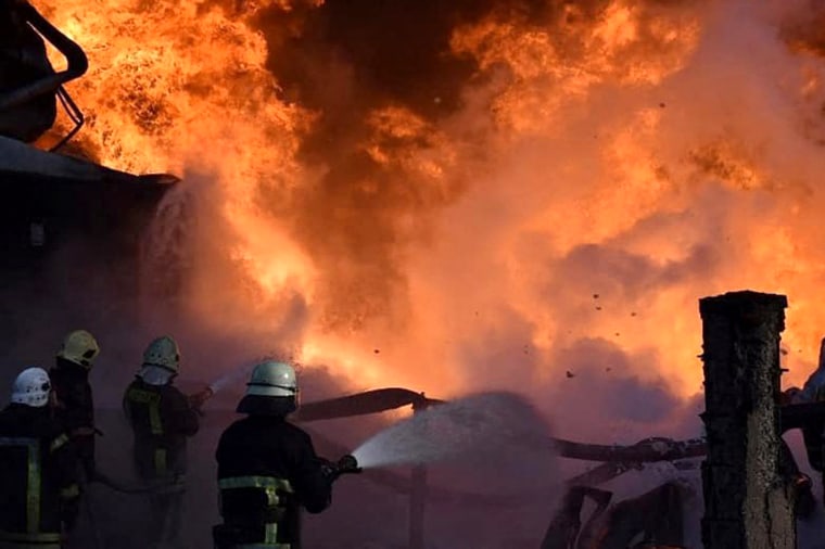 Firefighters tackle a blaze in Lutsk, western Ukraine after Russian missiles struck a fuel storage facility on March 29, 2022.