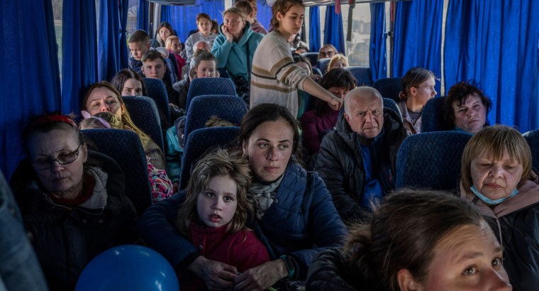 Image: Ukrainian evacuees on a bus carrying refugees, after crossing the Ukrainian border with Poland.