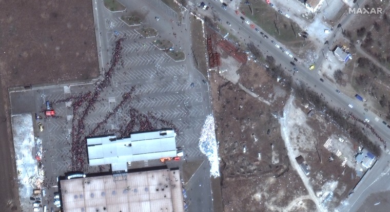 Image: A Maxar satellite image shows people in line waiting outside of a grocery store amidst reports of extreme food and water shortage, in Mariupol, Ukraine, on March 20, 2022