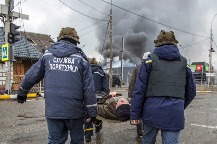 Rescuers evacuate an elderly man as Russia's attack on Ukraine continued in the town of Irpin, outside Kyiv on Wednesday.