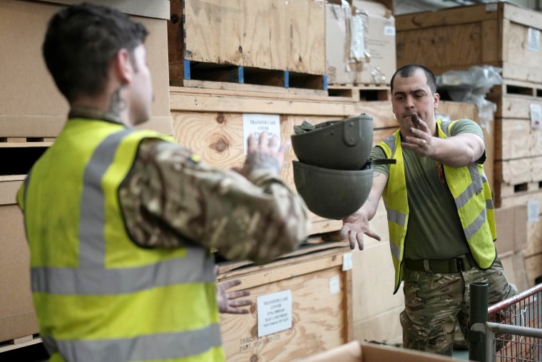 Soldiers from The Royal Anglian Regiment sort and pack some of the 84,000 ballistic helmets being shipped to soldiers and emergency service workers in Ukraine on Thursday in Donnington, England.