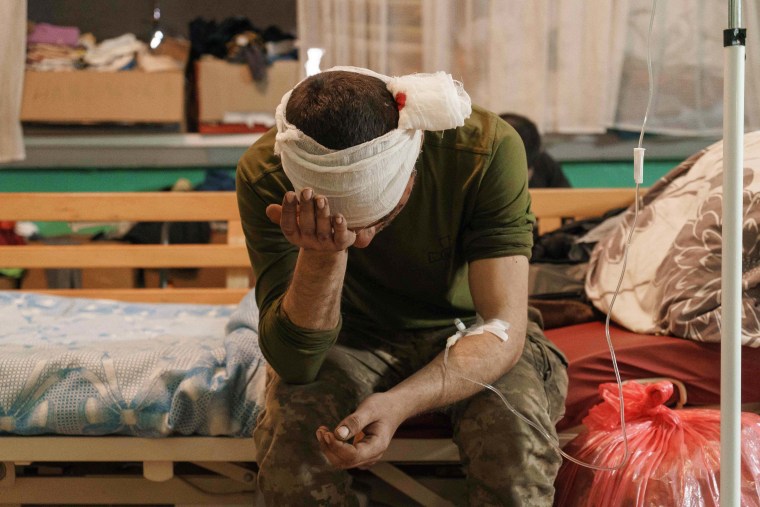 A wounded Ukrainian soldier waits for treatment in a room of the military hospital in Zaporizhzhya, on Thursday.