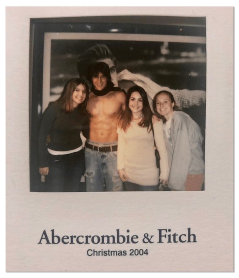 Image: A photo of three girls and a boy. The text on the photo card reads,"Abercrombie &amp; Fitch. Christmas 2004".