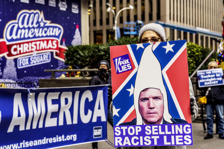 A protest group against Tucker Carlson and Fox News outside the News Corporation headquarters in New York, NY, in 2021.