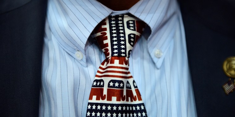 Image: A close-up of a tie decorated with  with elephants, the Republican party mascots.
