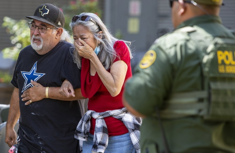 A woman cries as she leaves the Uvalde Civic Center