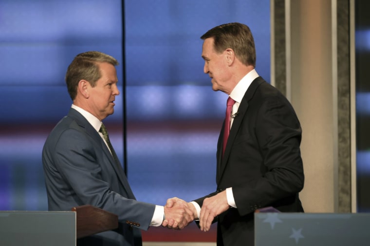 Image: Georgia Gov. Brian Kemp, left, shakes hands with former Sen. David Perdue