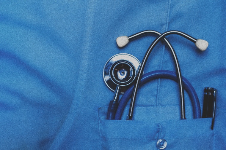 Image: A doctors scrubs with a stethoscope in the pocket.