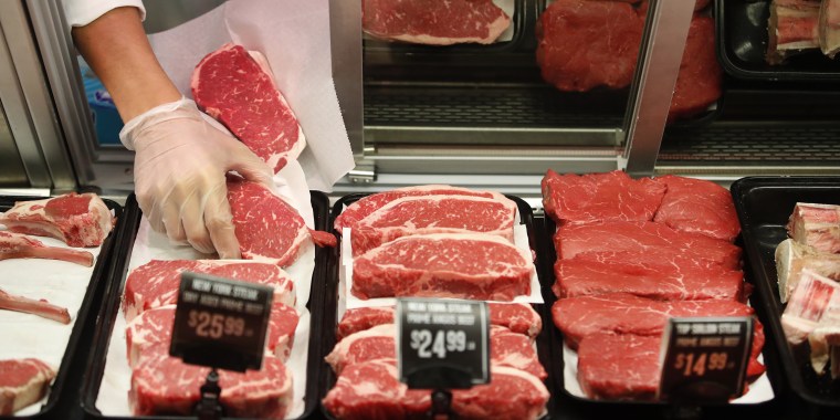 Image: A worker prepares a customer's meat order at a grocery store in Salt Lake City on Oct. 21, 2021.