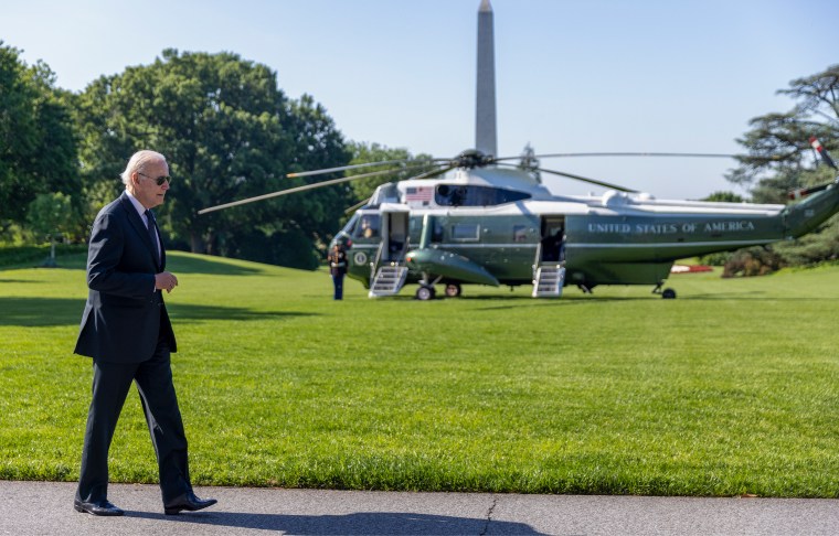 Image: Joe Biden walking on the white house lawn.