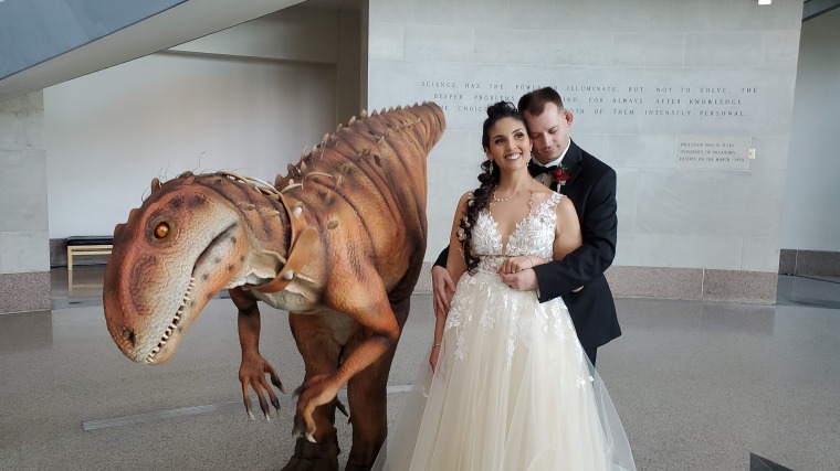 Matthew and Alexandra Fuhrken, married May 2022, at the Sam Noble Museum, in Norman, Oklahoma, with a dinosaur courtesy of Characters for Hire.