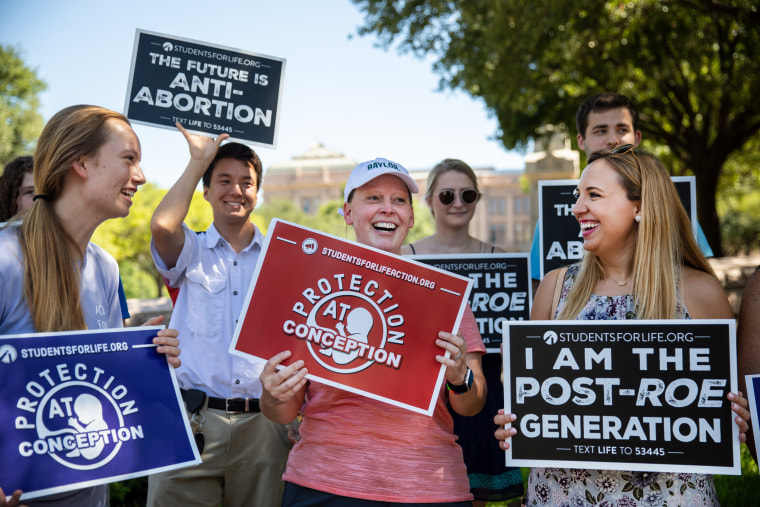 Image: From left: Megan Roos, Emily Roos and Rebecca Parma celebrate Roe v. Wade being overturned outside of the Texas Capitol in Austin, on June 25, 2022. (Montinique Monroe/The New York Times)
