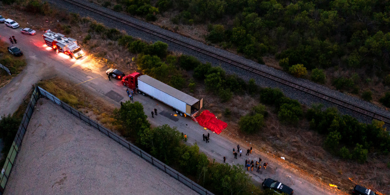 Image: Aerial view showing law enforcement officers investigating a tractor trailer.