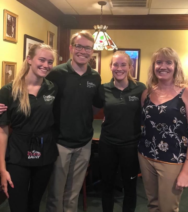 Sarah Davey Cahill (right) and the third generation of family members to work at Davey’s Irish Pub and Restaurant: from left, her children Kathryn, Patrick and Bridget. (Her youngest, Clare, also a Davey’s staffer, is not pictured.) 