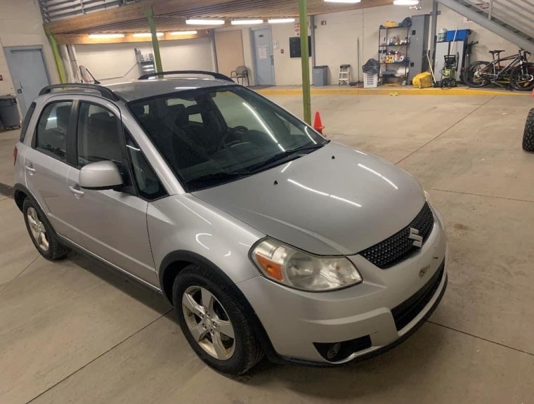 Casey's silver Suzuki SX4.