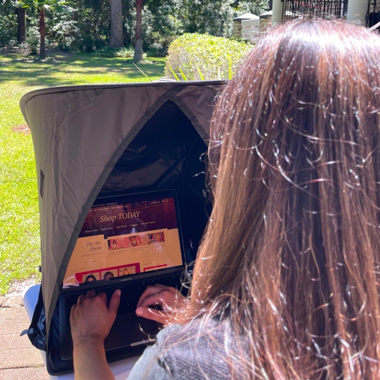 Editorial assistant Jillian Ortiz using the Vatalyst Laptop Sun Shade