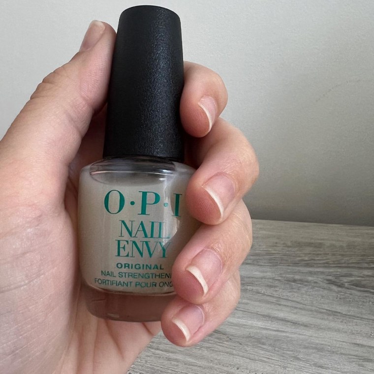 Hand holding OPI nail polish