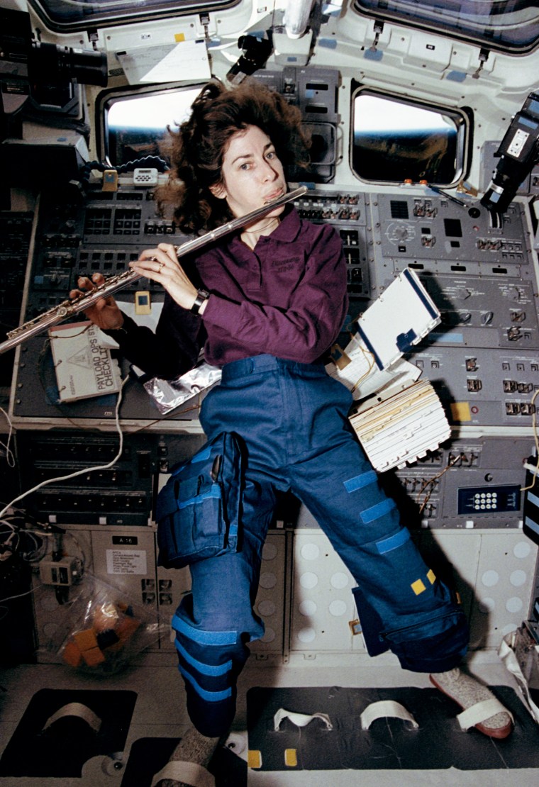 Ellen Ochoa plays the flute aboard the shuttle Discover