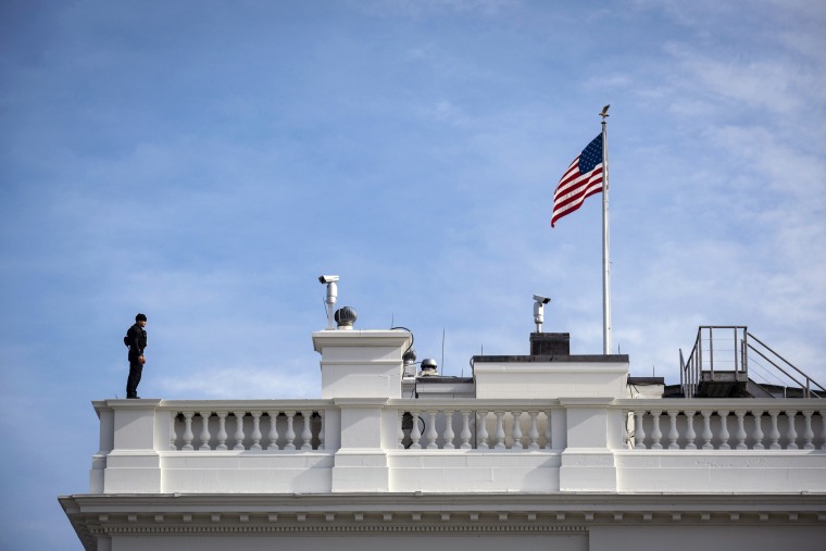 Image: A Secret Service agent stands guard on the roof of the White House in Washington in 2020.