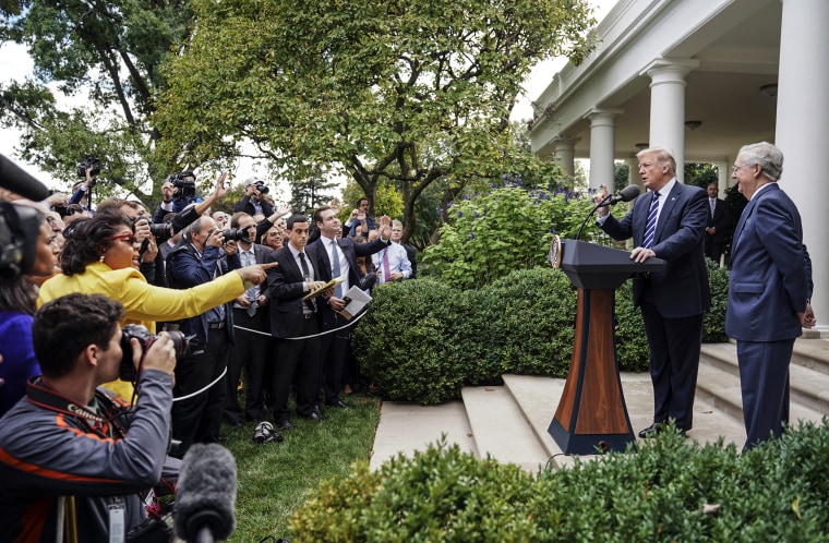April Ryan, left, the Washington bureau chief for American Urban Radio Networks asks questions to President Donald Trump and Senate Majority Leader Mitch McConnell of Ky., in the Rose Garden of the White House on Oct. 16, 2017.