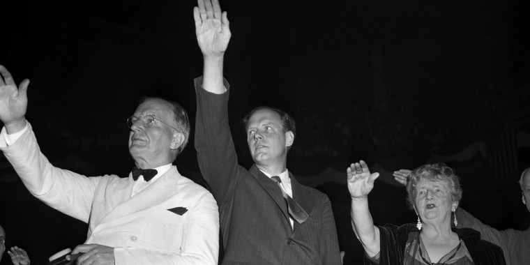 Sen. Burton K. Wheeler, Charles Lindbergh, and Kathleen Norris pledge allegiance to the American flag at an America First Committee rally