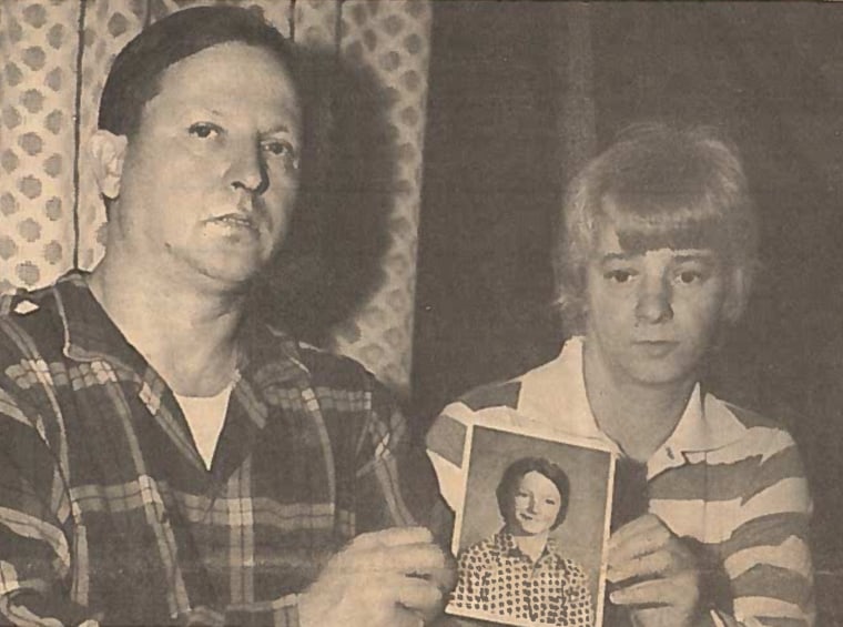 Lawrence and Pat Heikell holding up a photo of missing son Karl