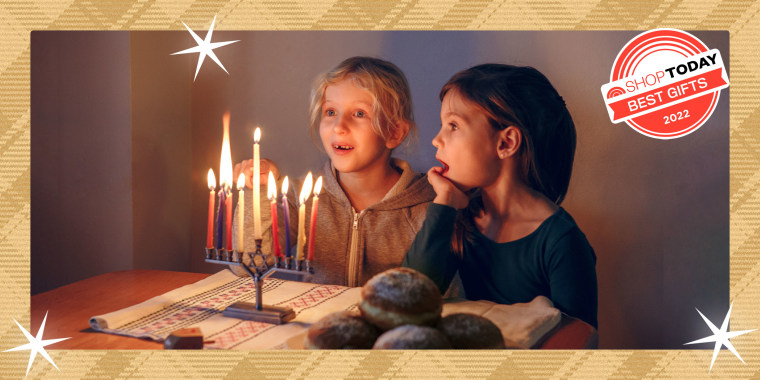 Girls Friends Lighting Candles On Menorah For Traditional Winter Jewish Hanukkah Holiday At Home