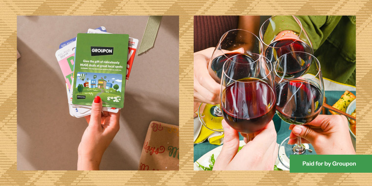 Hand holding a Groupon gift card and friends with wine