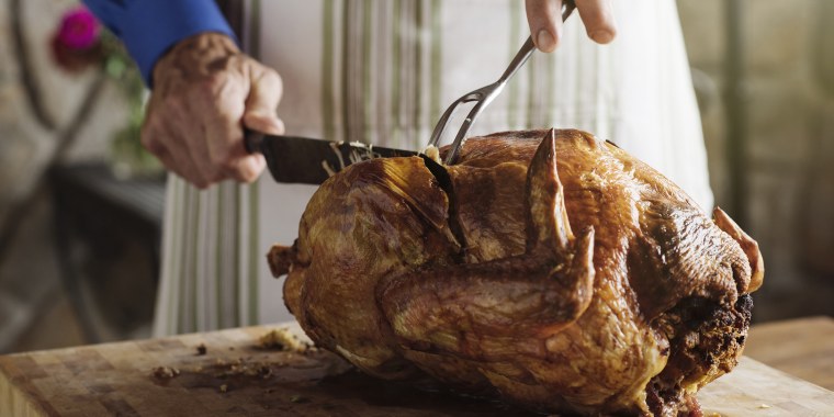 A man carving a turkey — an image we're very accustomed to seeing.